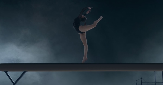 Gymnast on balance beam.